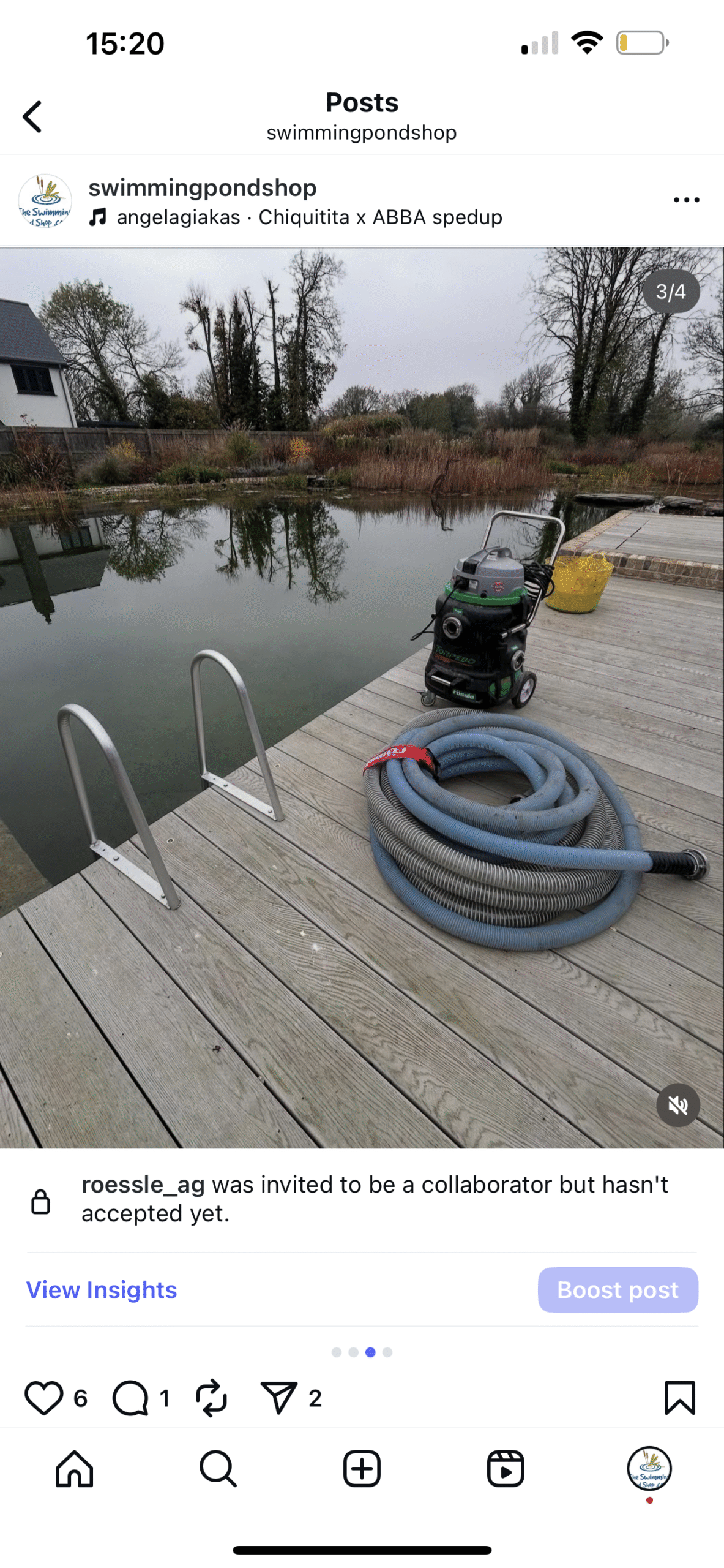 Swimming pond with cleaning equipment on wooden deck